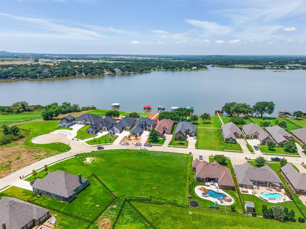 an aerial view of a houses with outdoor space lake view and houses