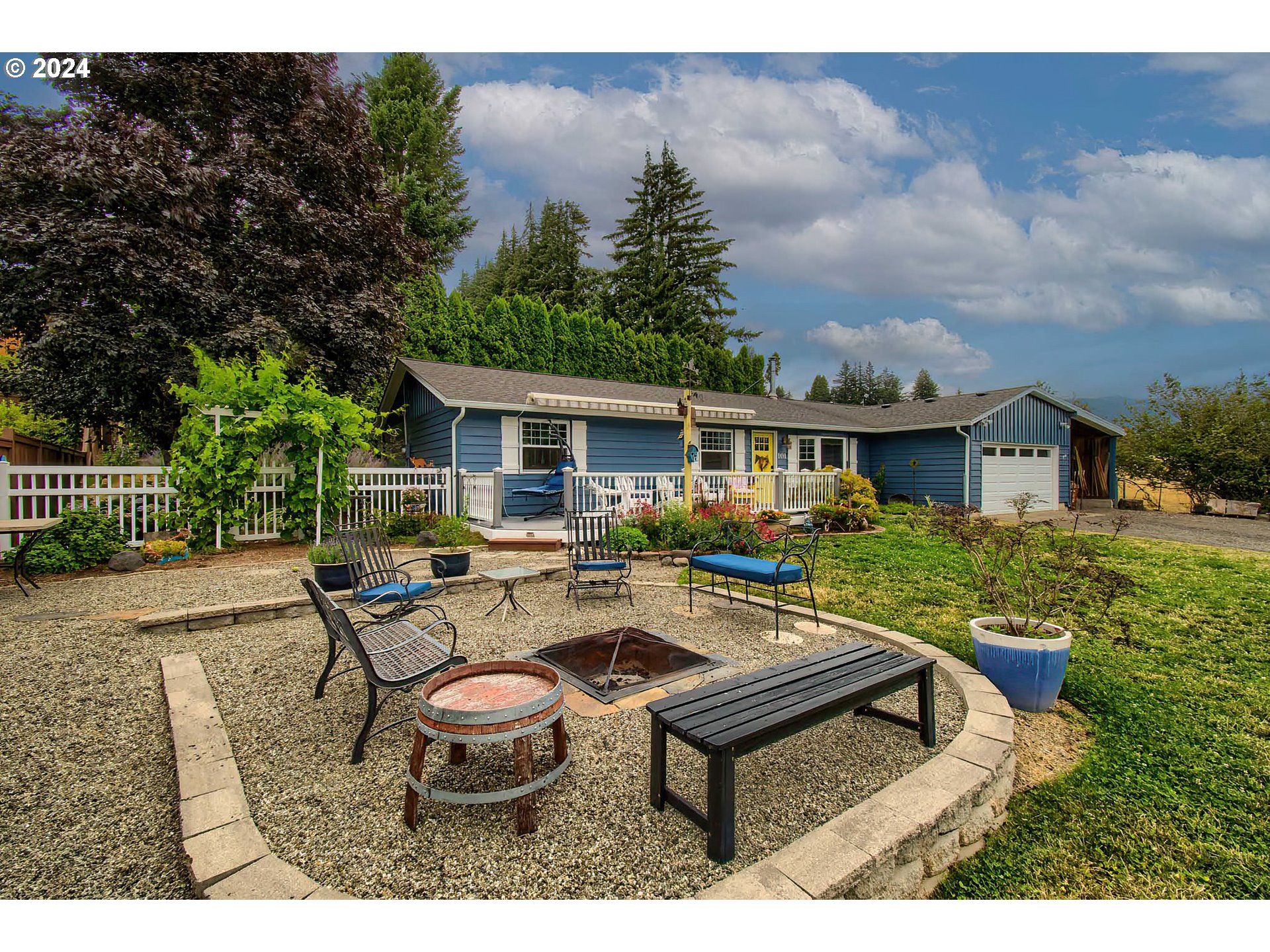 a view of a house with backyard and sitting area