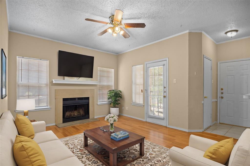 a living room with furniture a fireplace and a flat screen tv