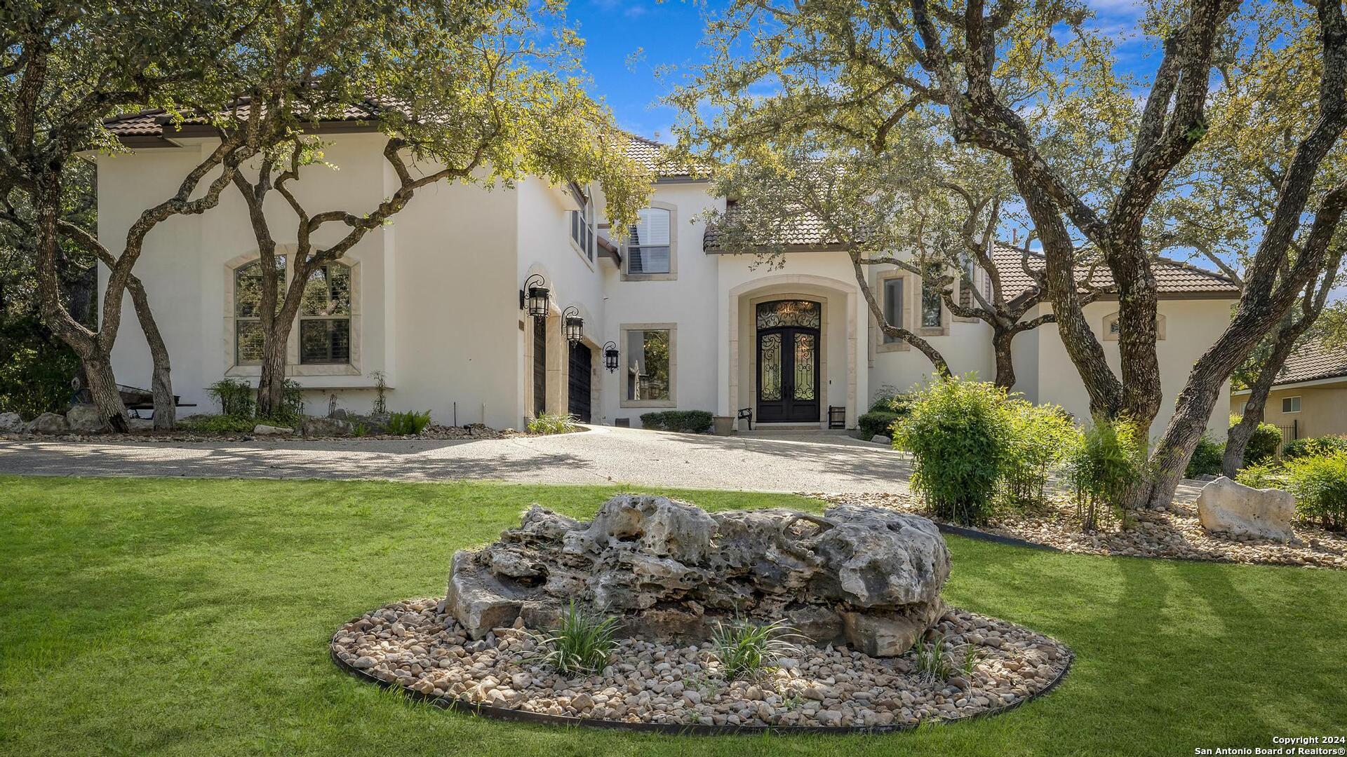 a view of a house with a yard patio and fire pit