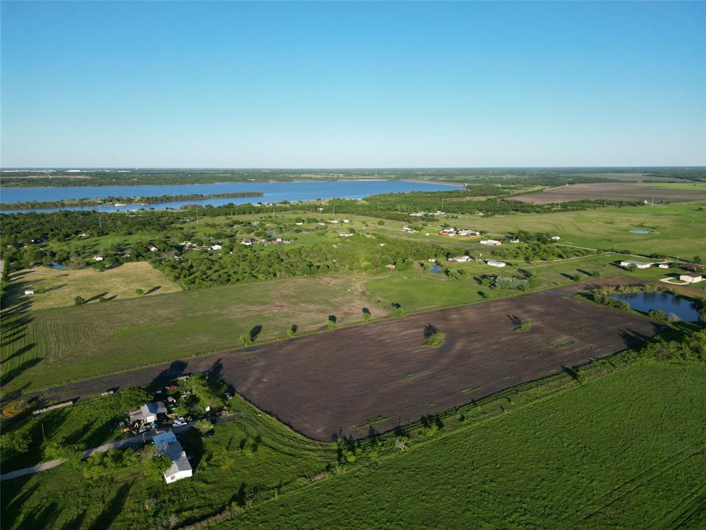 an aerial view of ocean with residential house