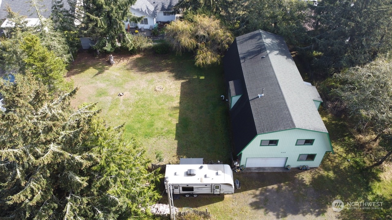 an aerial view of a house with a yard