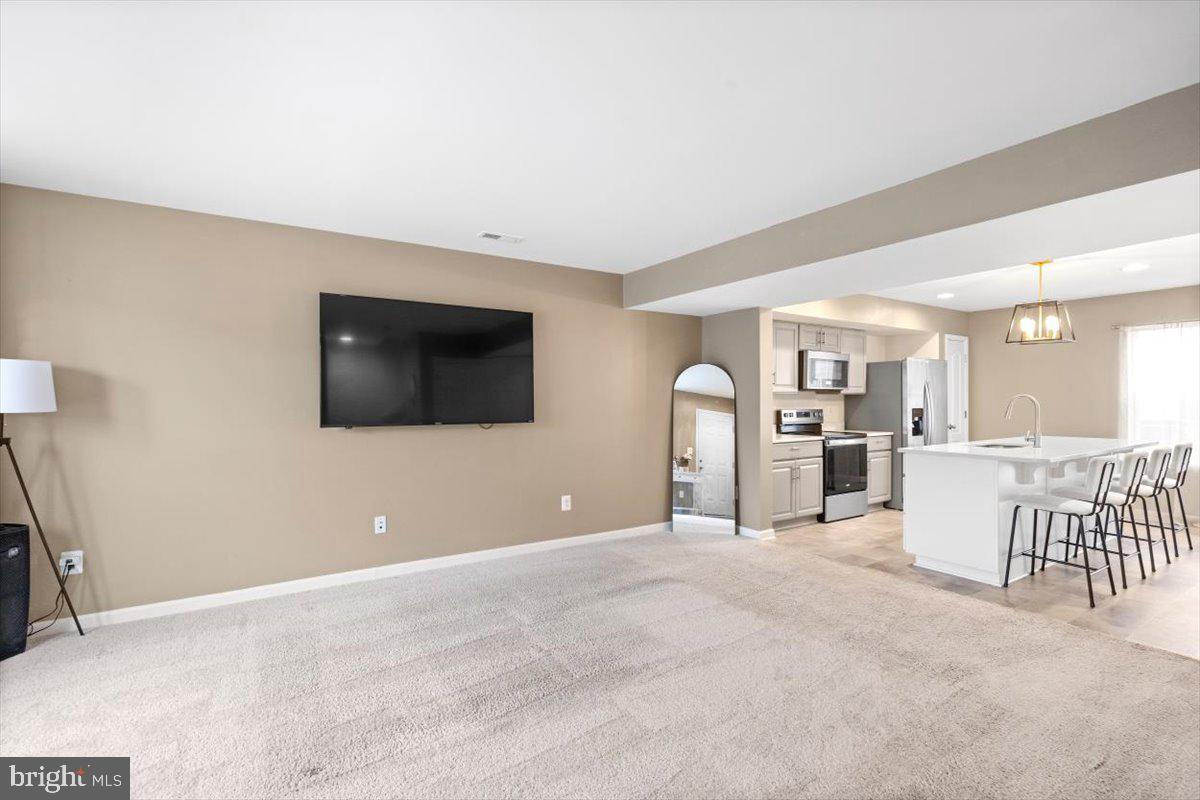 a view of a livingroom with furniture and a flat screen tv