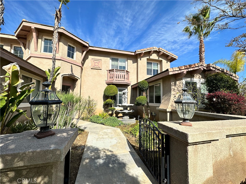 a view of a house with yard and sitting area