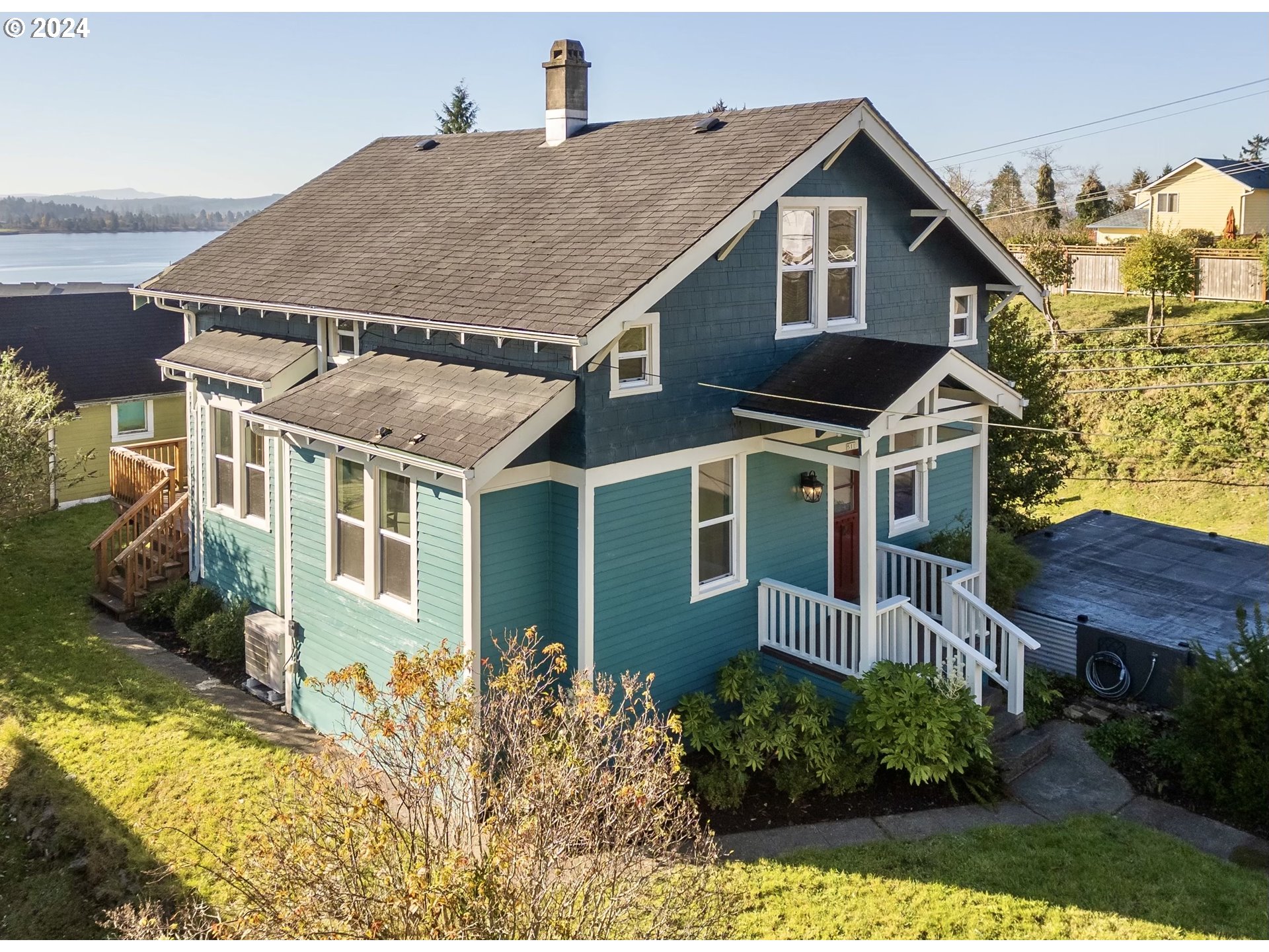 a aerial view of a house with a yard and potted plants