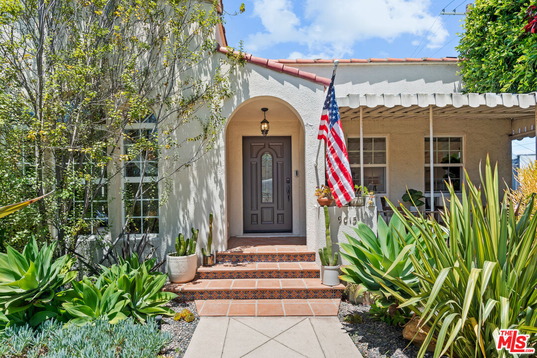 a front view of a house with a plants