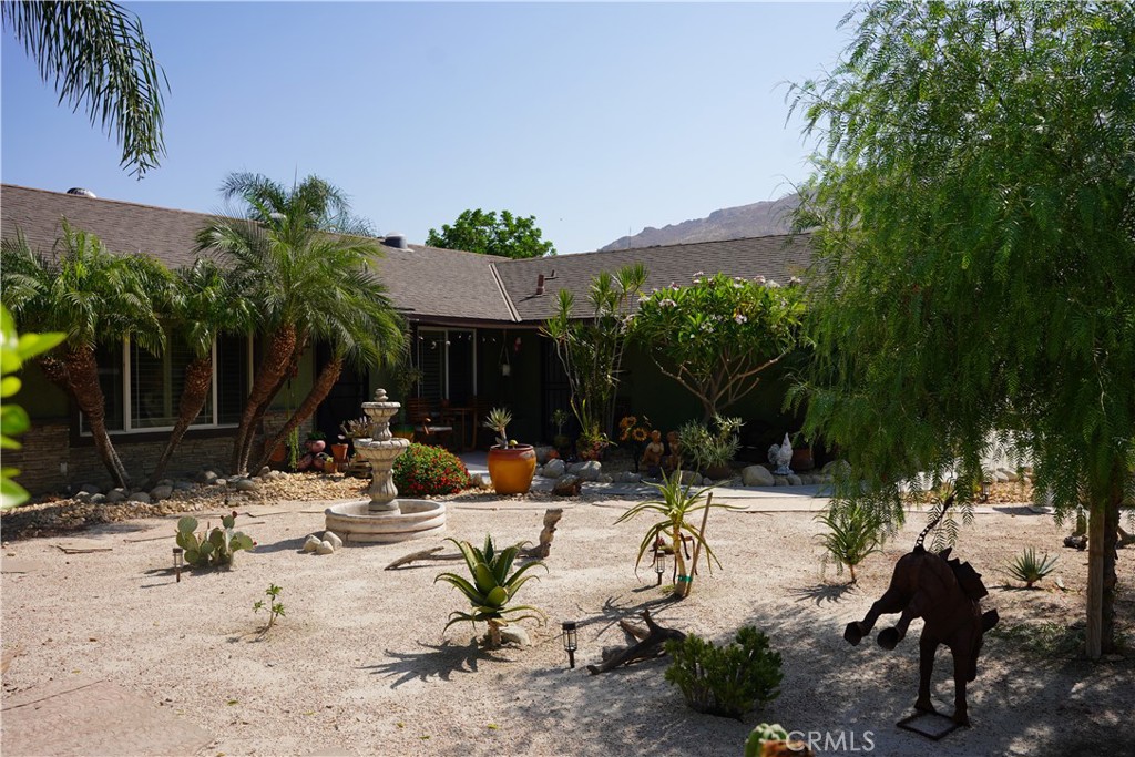 a view of swimming pool with outdoor seating and plants