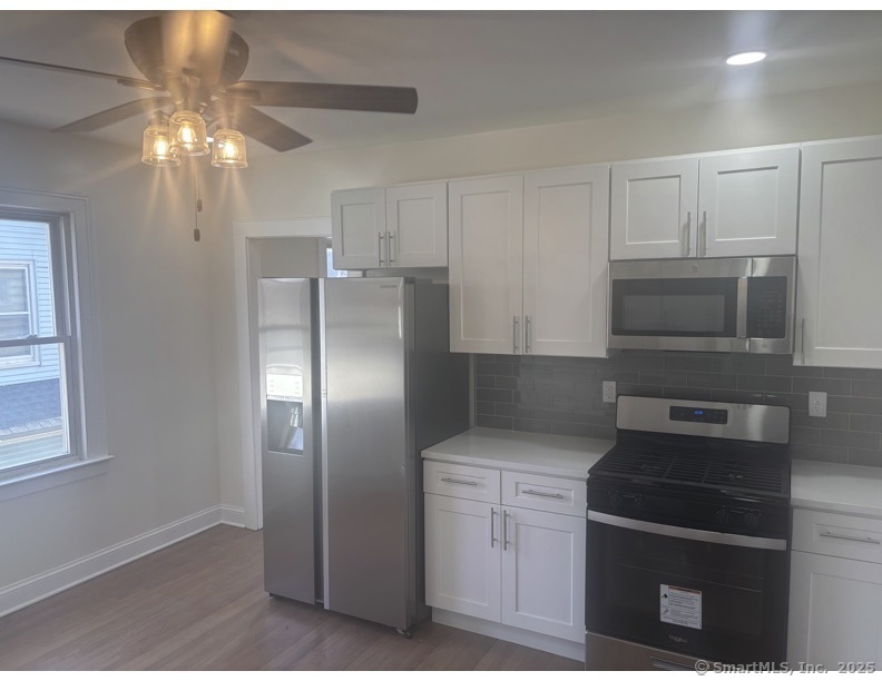 a kitchen with cabinets and stainless steel appliances