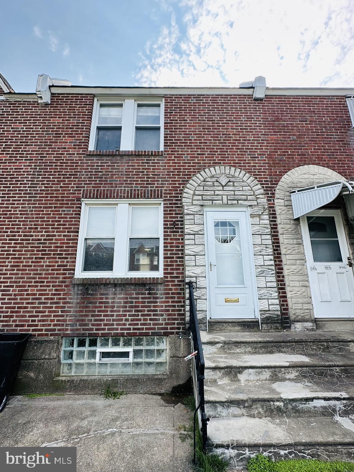 a front view of a house with stairs