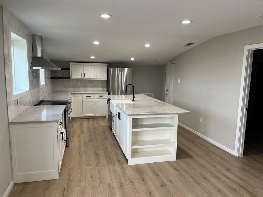 a kitchen with a refrigerator and a sink