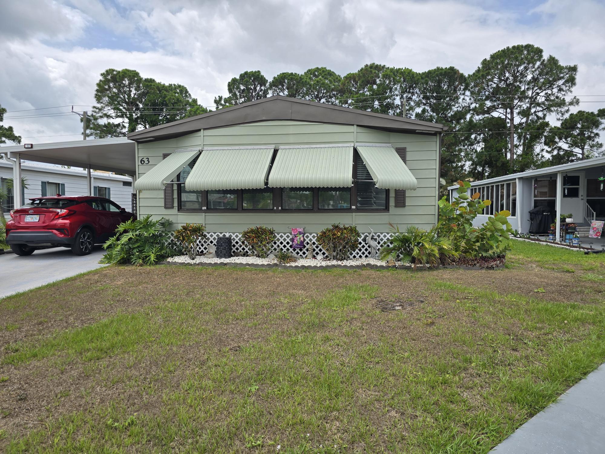 a front view of a house with a garden