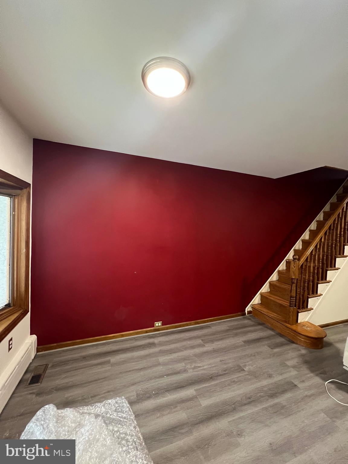 a view of a room with wooden staircase and white walls