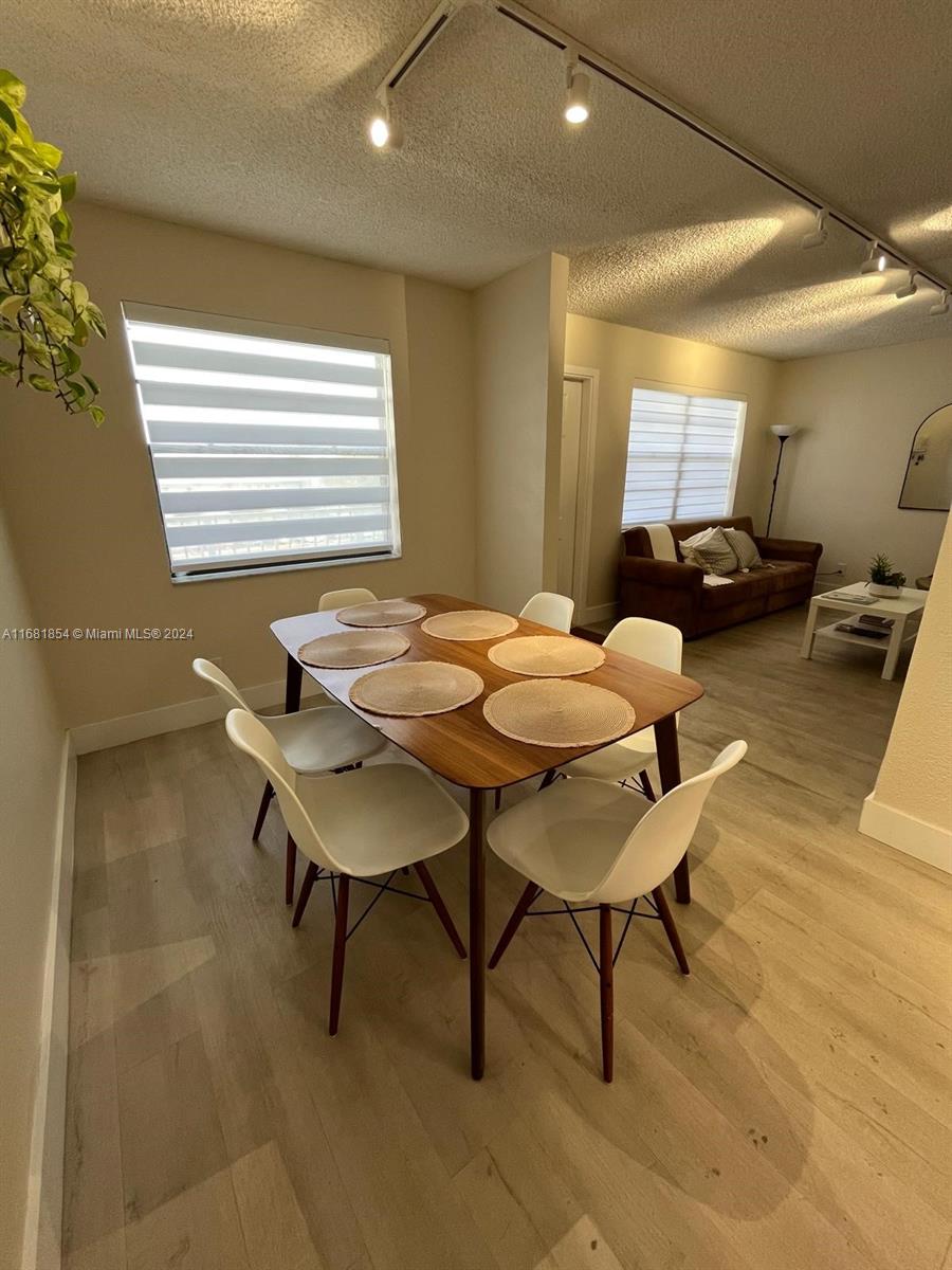 a view of a dining room with furniture and wooden floor