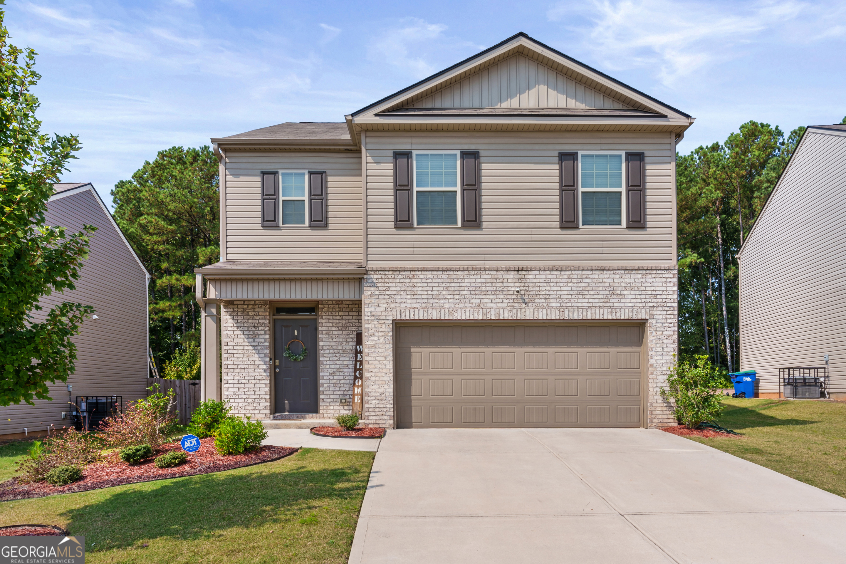 a front view of a house with a yard and garage