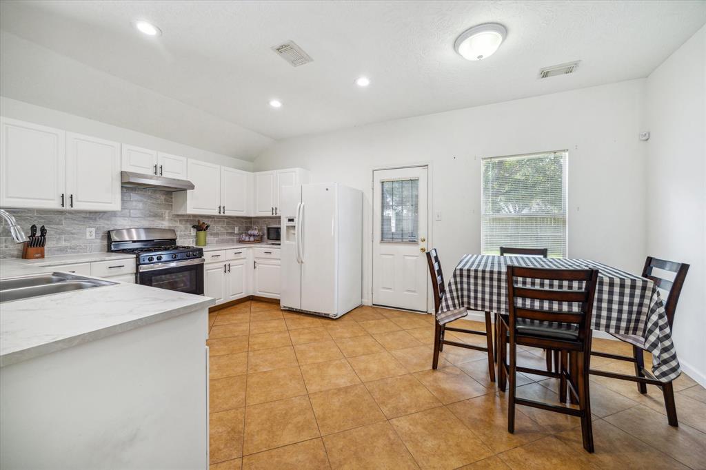 Discover the heart of your new home in this spacious kitchen and dining area, perfect for entertaining and culinary collaborations. Abundant cabinet space and generous countertops invite you to craft your culinary masterpieces, while the included double-wide refrigerator with ice maker adds convenience and value. Seamless backyard access ensures your gatherings effortlessly extend to outdoor enjoyment.