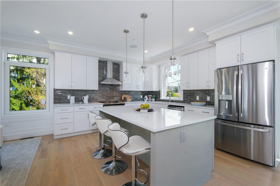 a kitchen with refrigerator cabinets and wooden floor