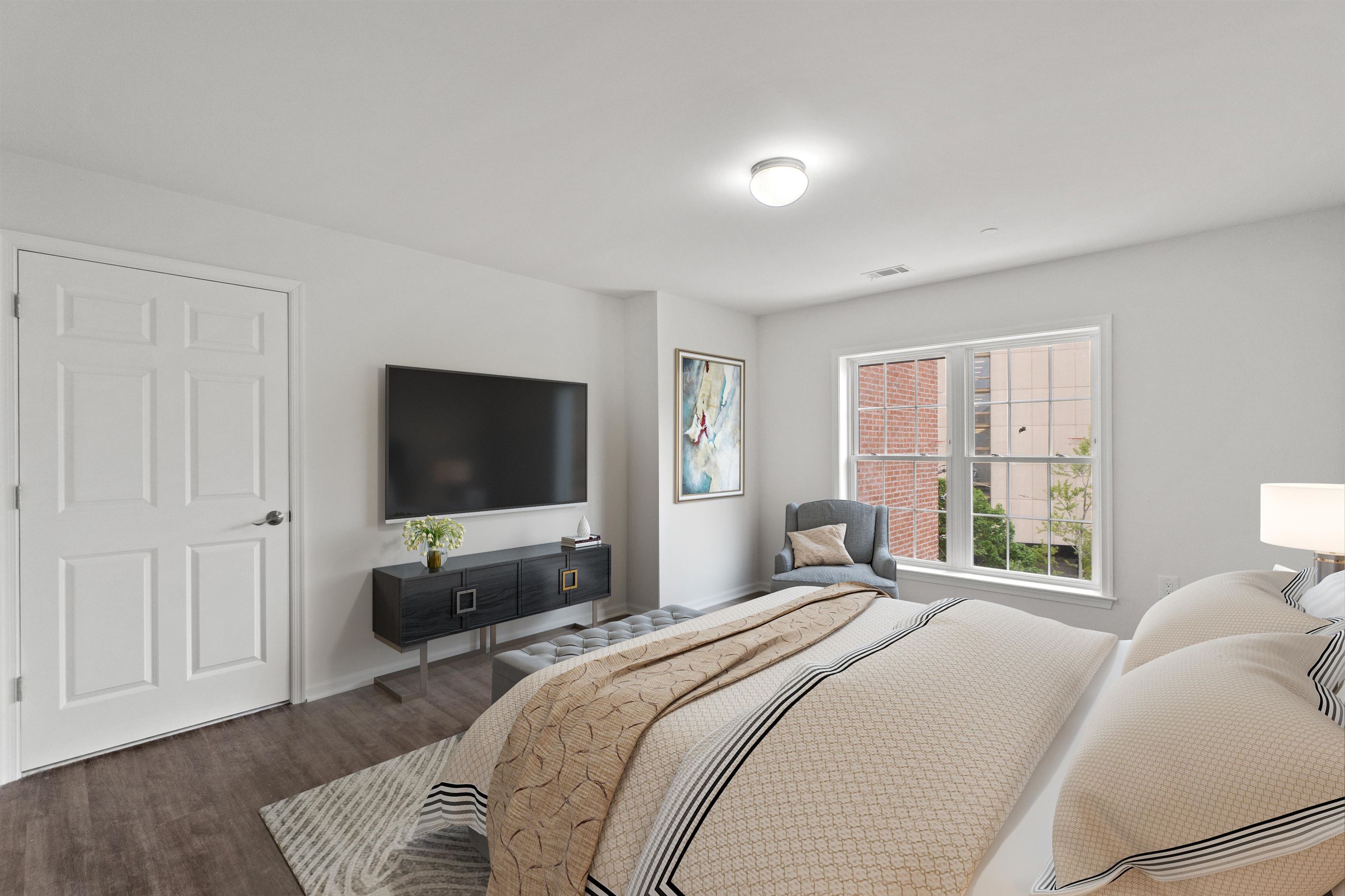 a bedroom with a bed and a flat screen tv