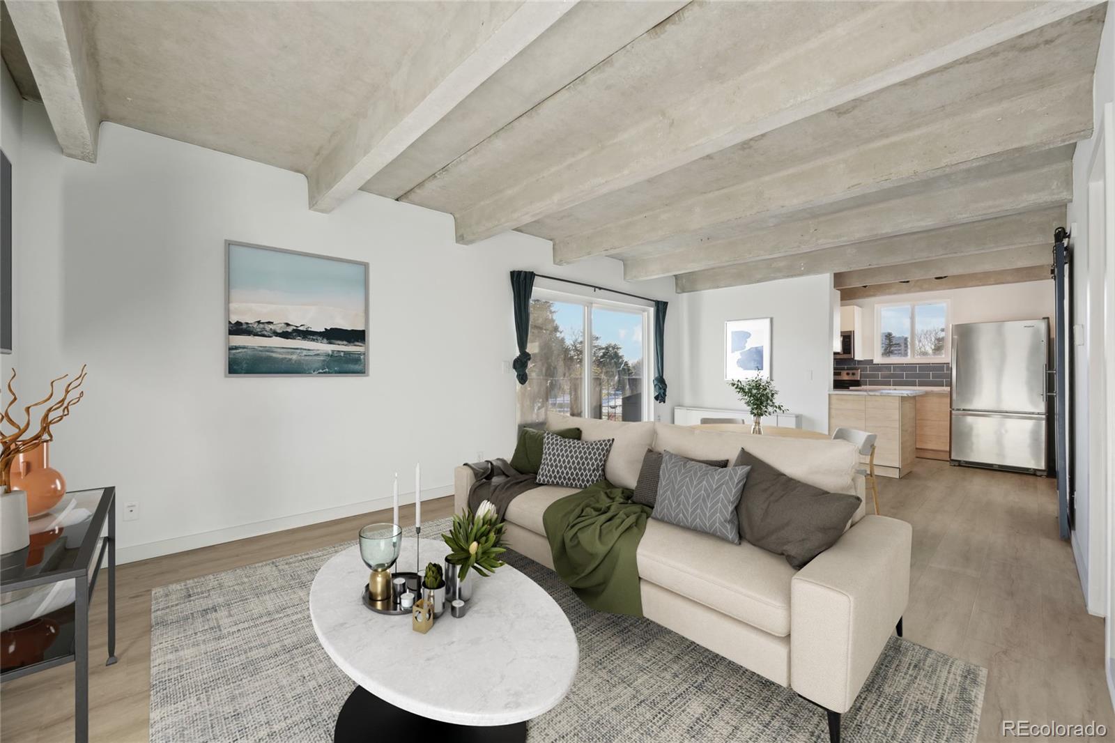 a living room with furniture a dining table and kitchen view