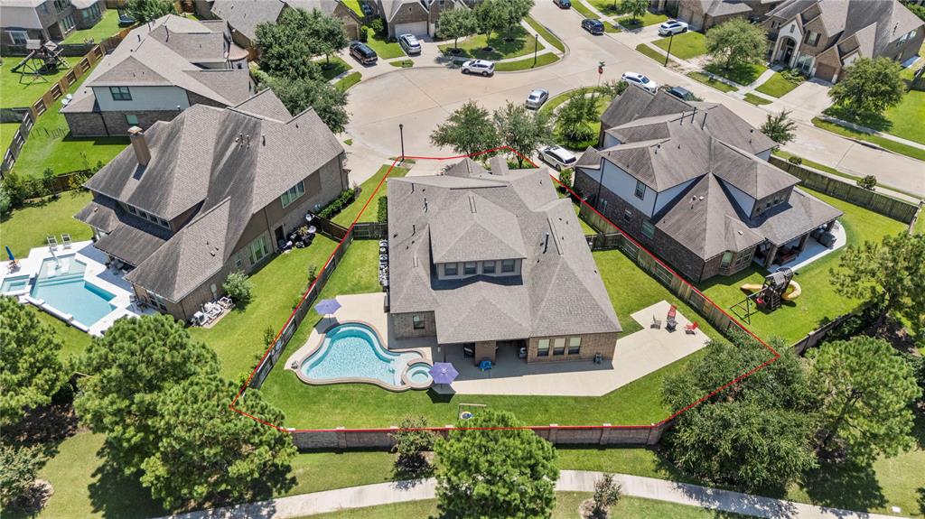 an aerial view of a house with a swimming pool