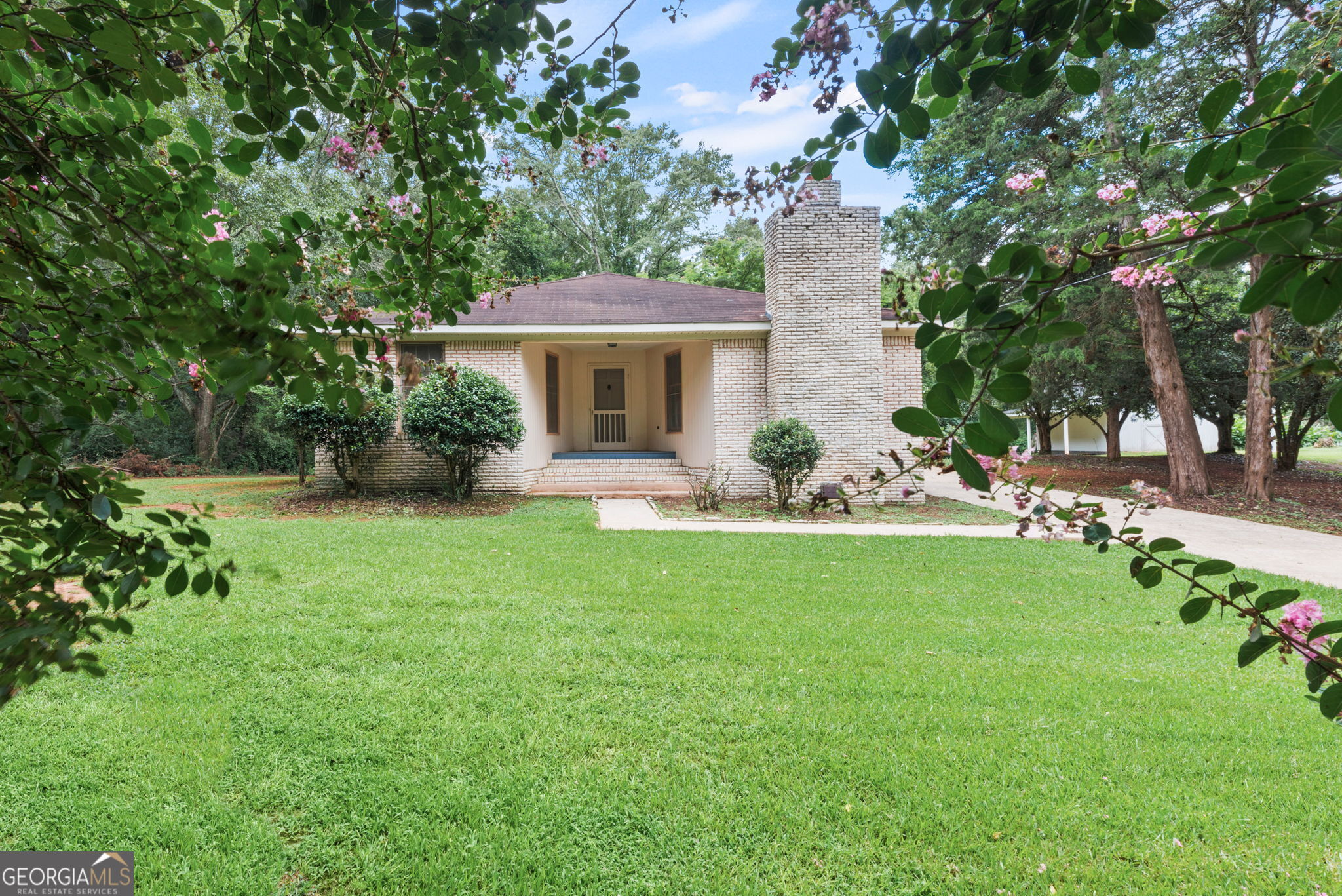 a front view of a house with garden