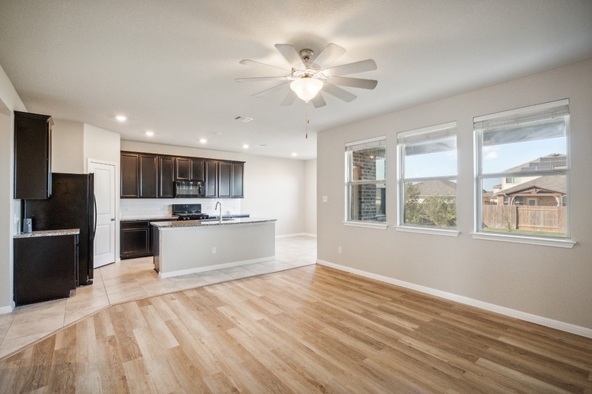 a large kitchen with kitchen island a sink stainless steel appliances and cabinets