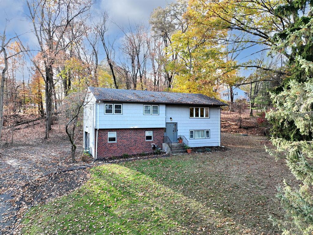 Split foyer home featuring a front lawn