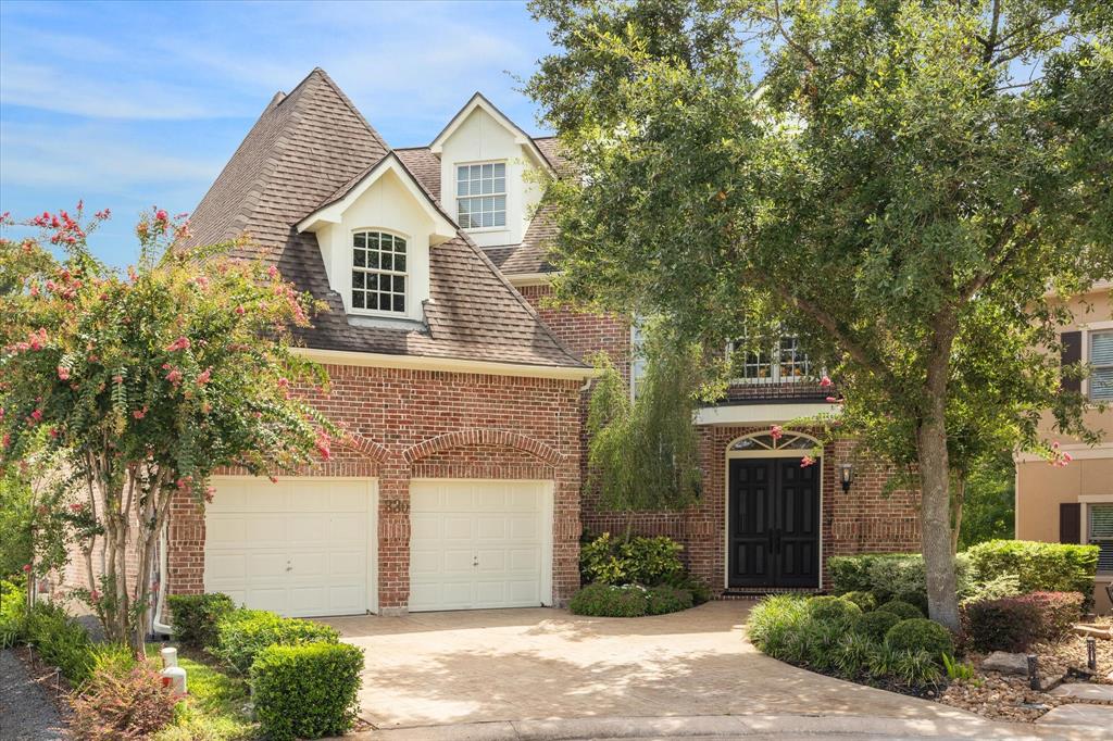 Beautiful traditional brick home in wooded setting and gated community.