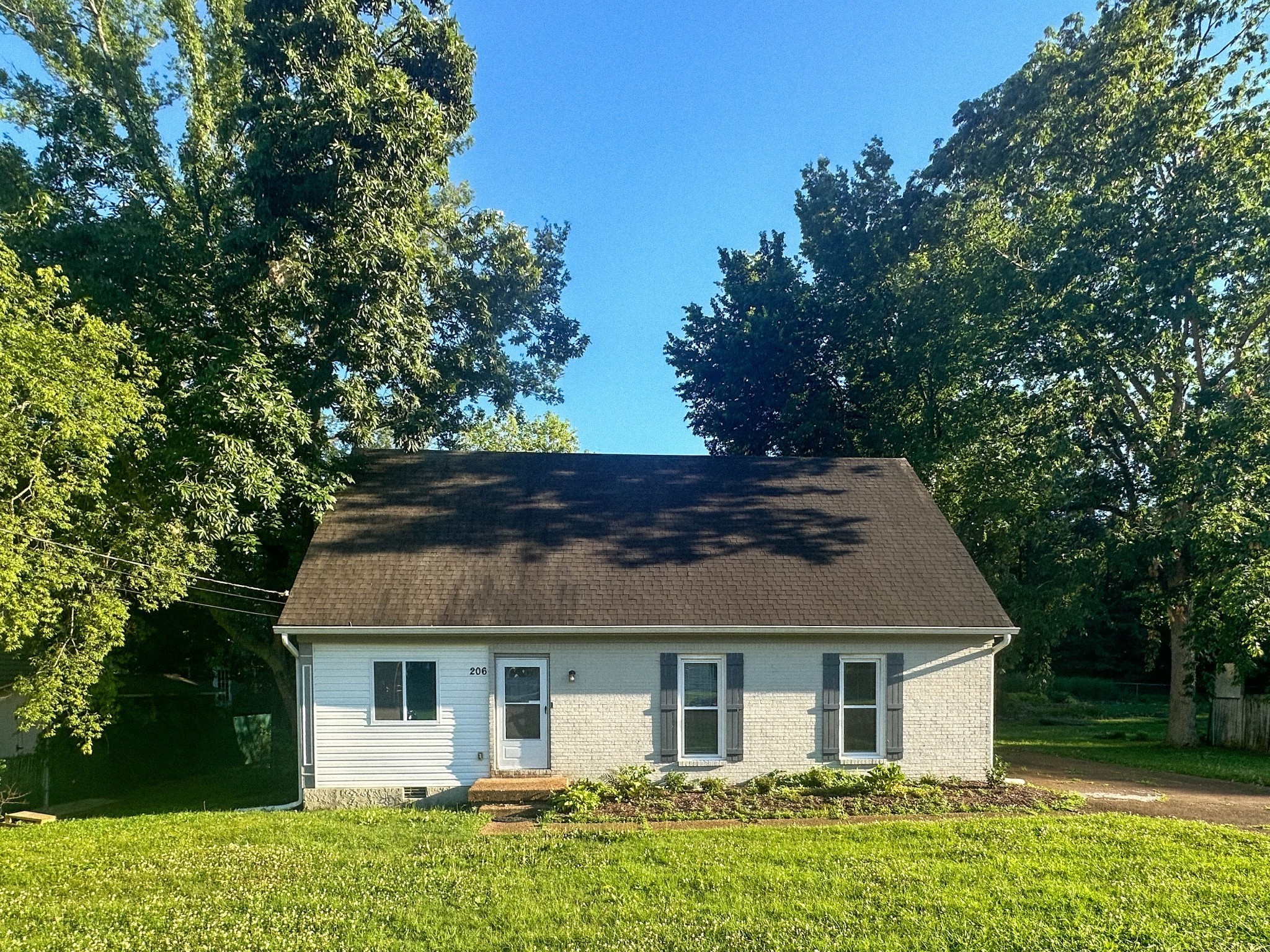 a front view of a house with a garden