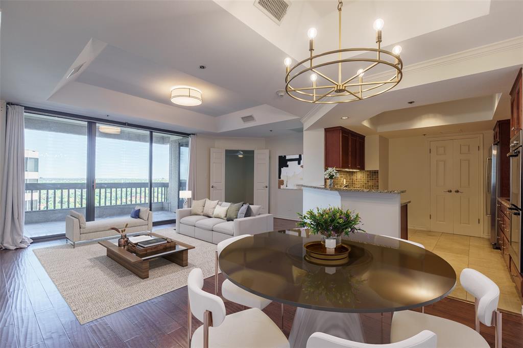 a living room with fireplace furniture and a chandelier