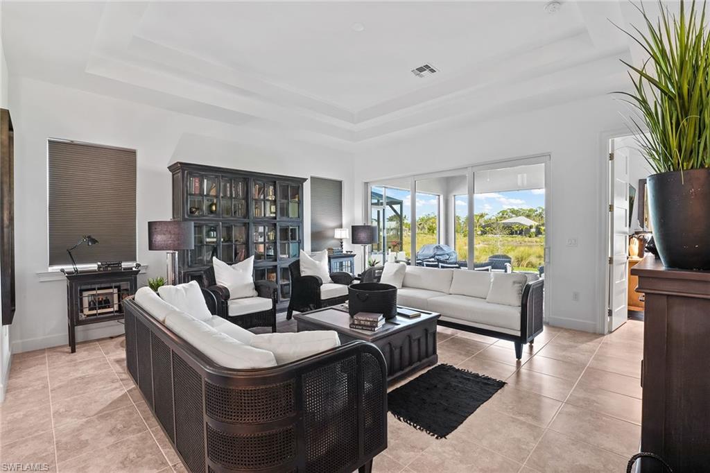 a living room with furniture large window and a flat screen tv