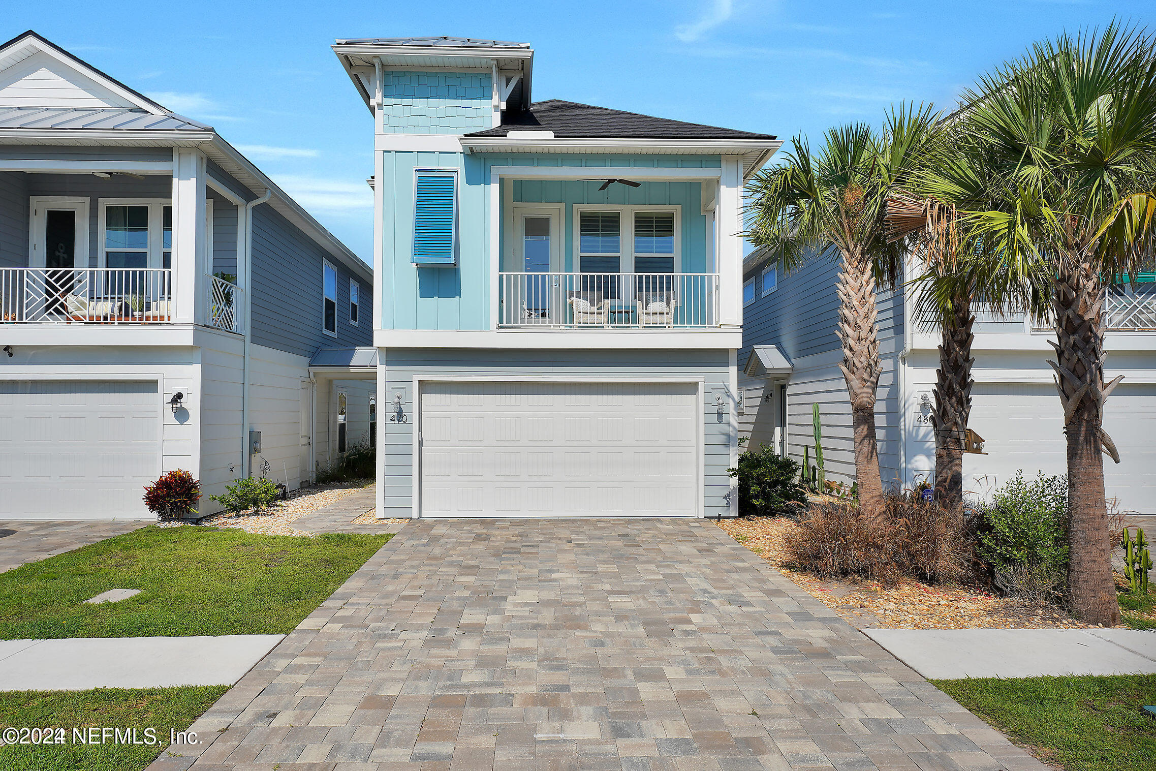 a front view of a house with a garden and yard