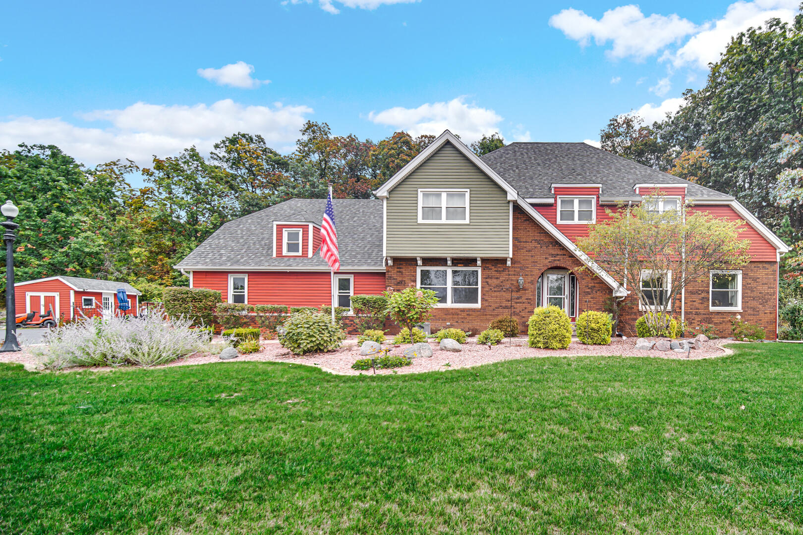 a front view of a house with a garden and yard