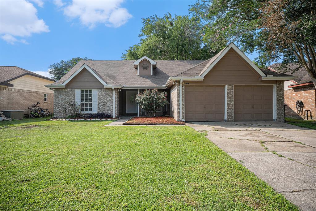 a front view of a house with a garden and yard