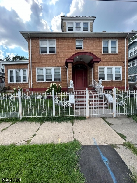 a front view of a house with a garden and plants