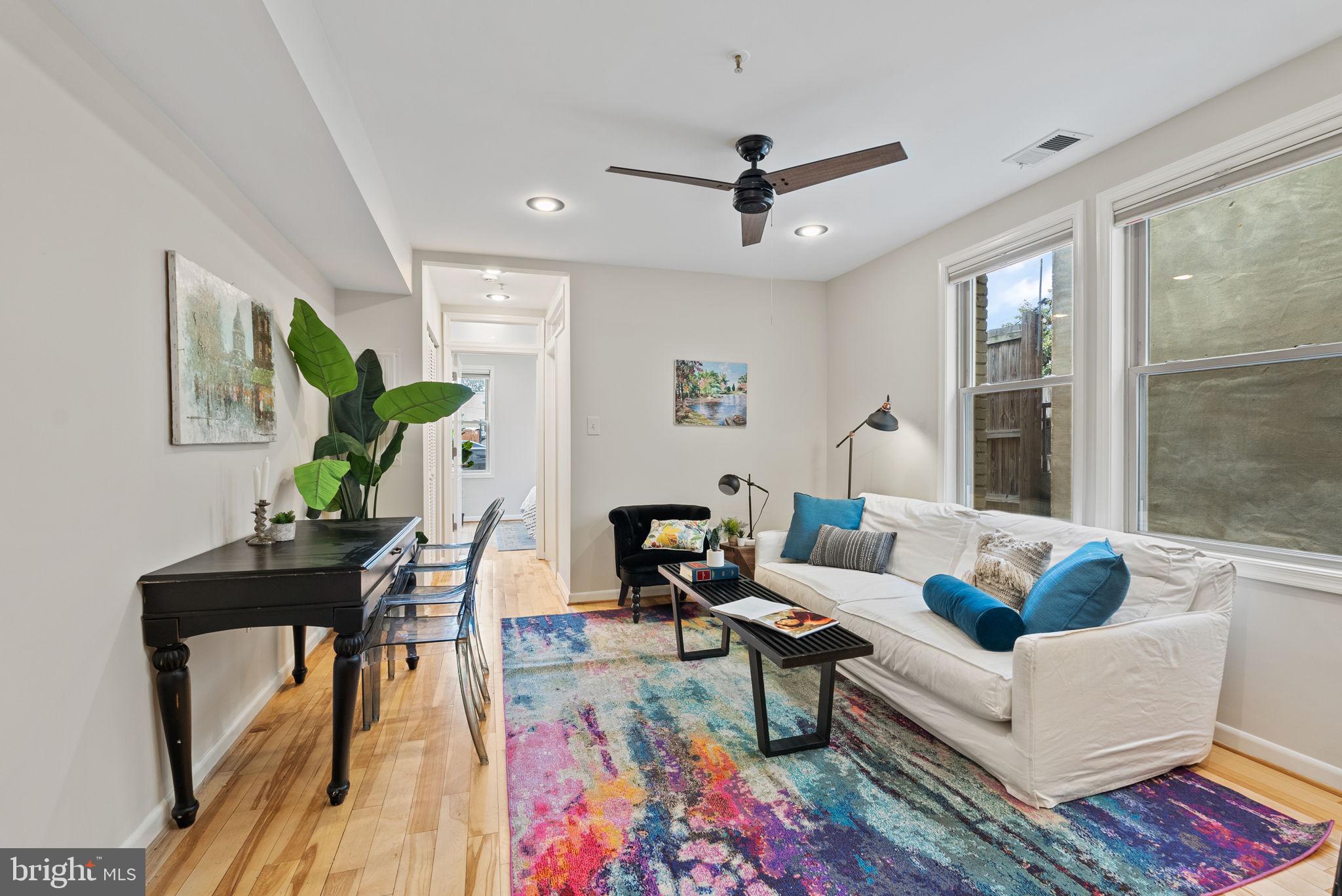 a living room with furniture and a wooden floor