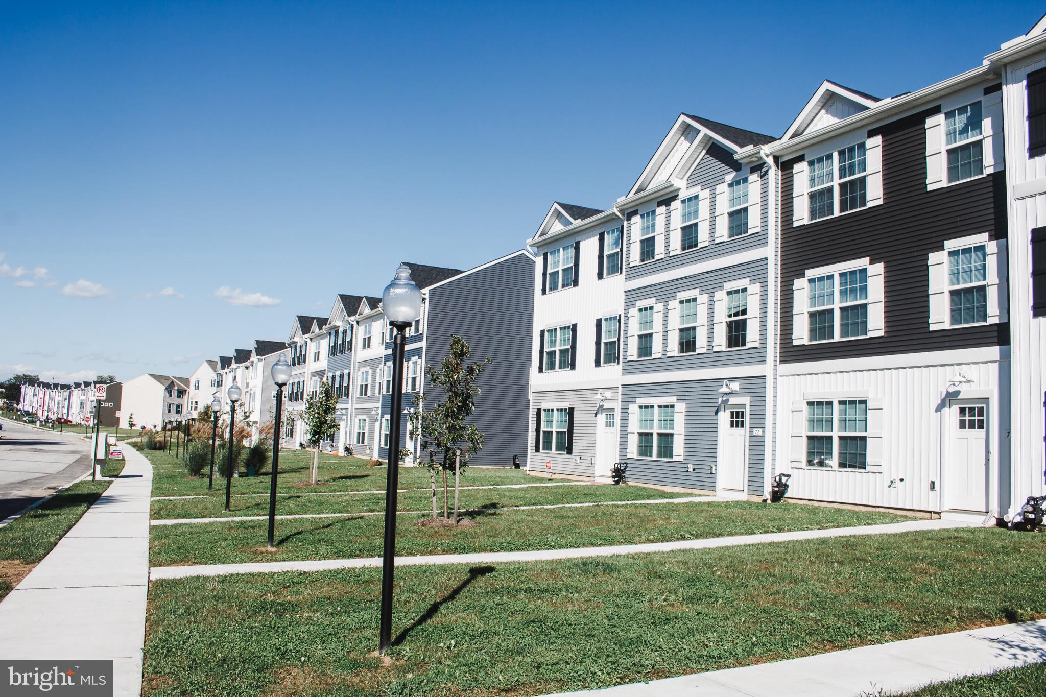 a front view of a residential apartment building with a yard