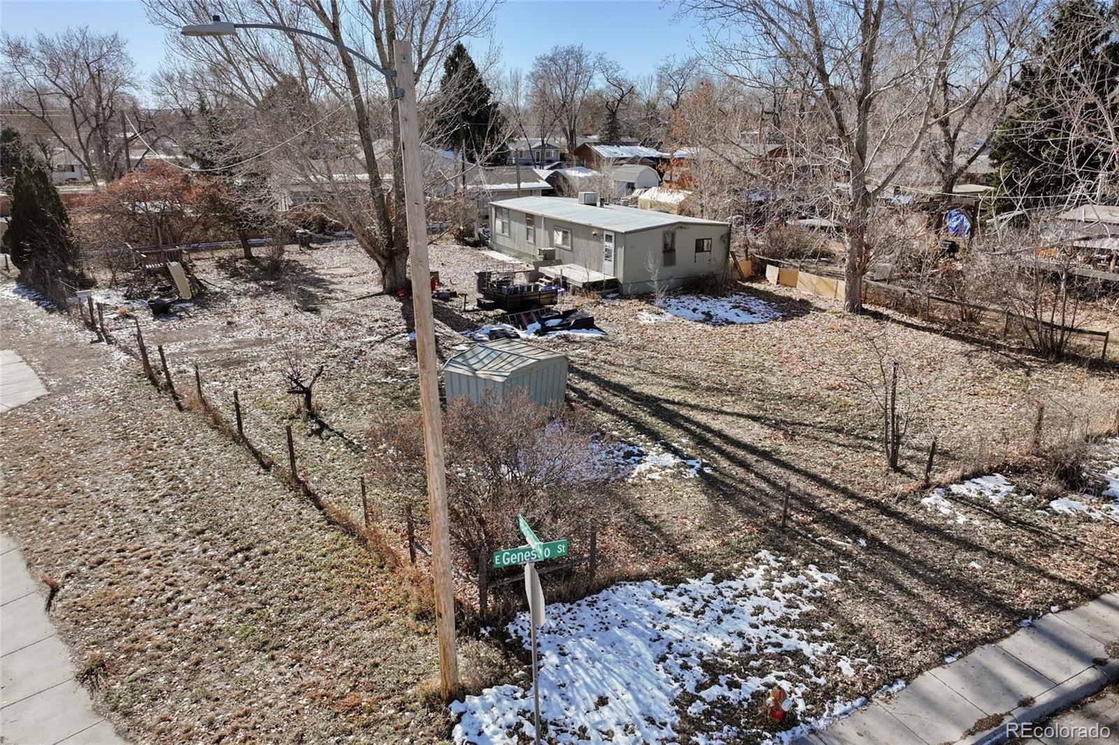 a view of a yard with wooden fence