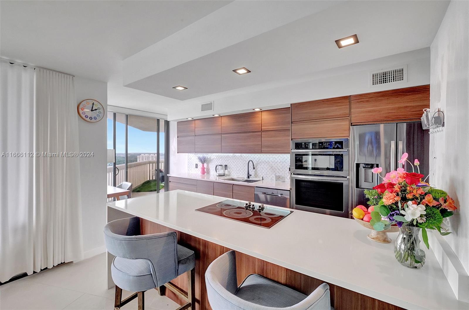 a kitchen with stainless steel appliances kitchen island granite countertop a sink and cabinets