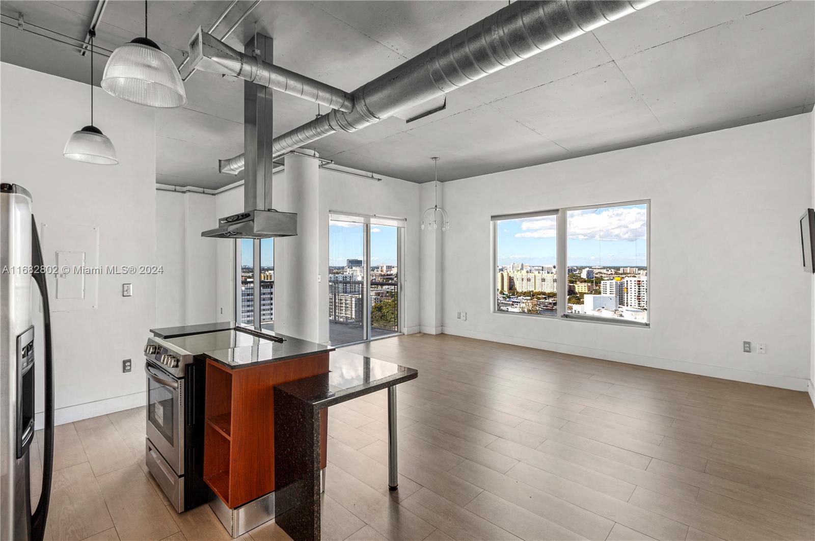 a view of a kitchen with furniture and a floor to ceiling window