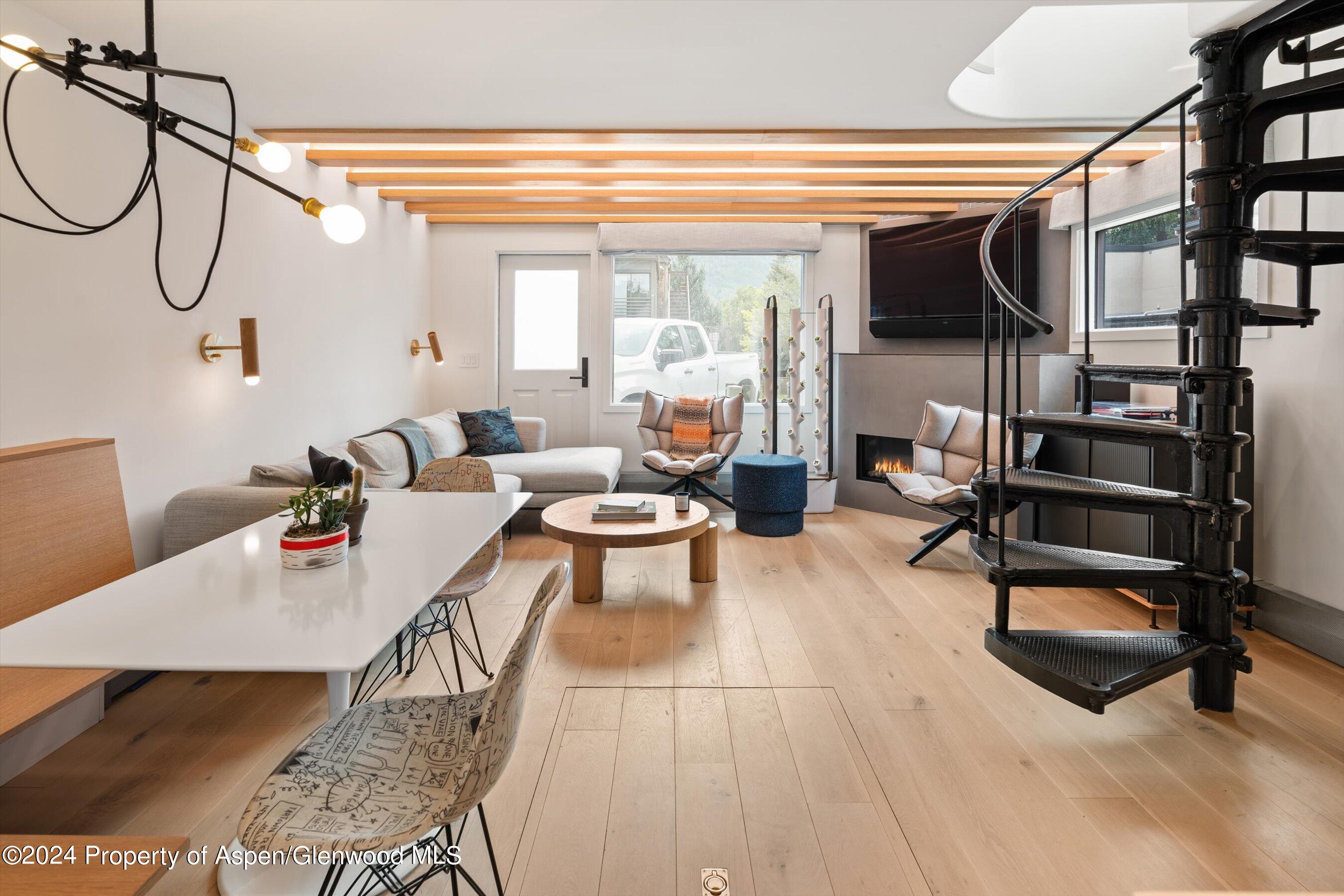 a living room with furniture a rug and white walls