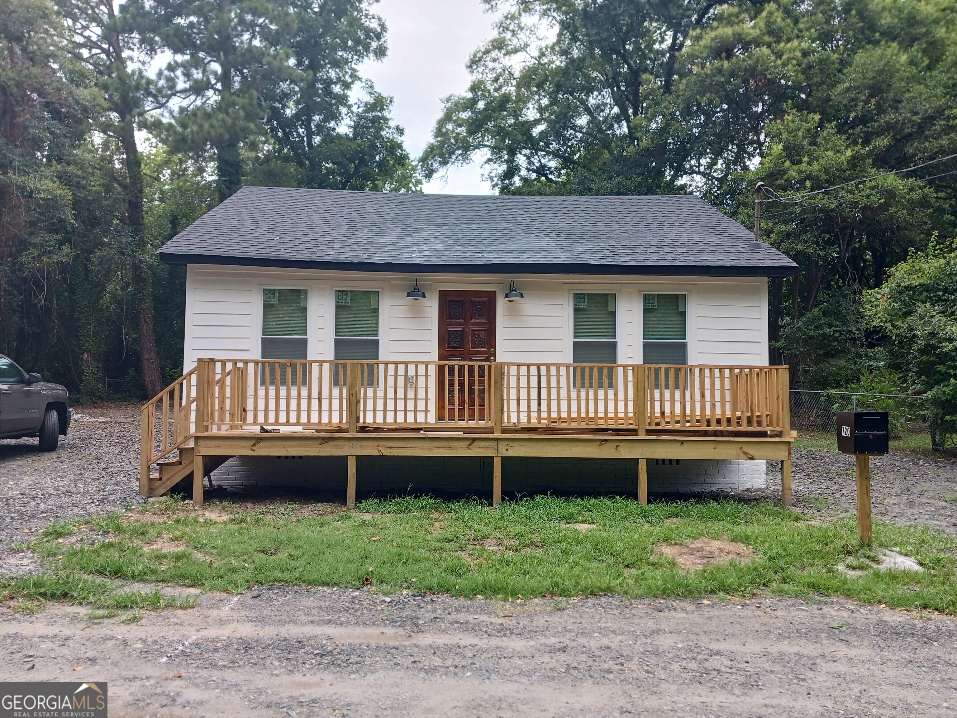 a view of a house with a yard and a deck