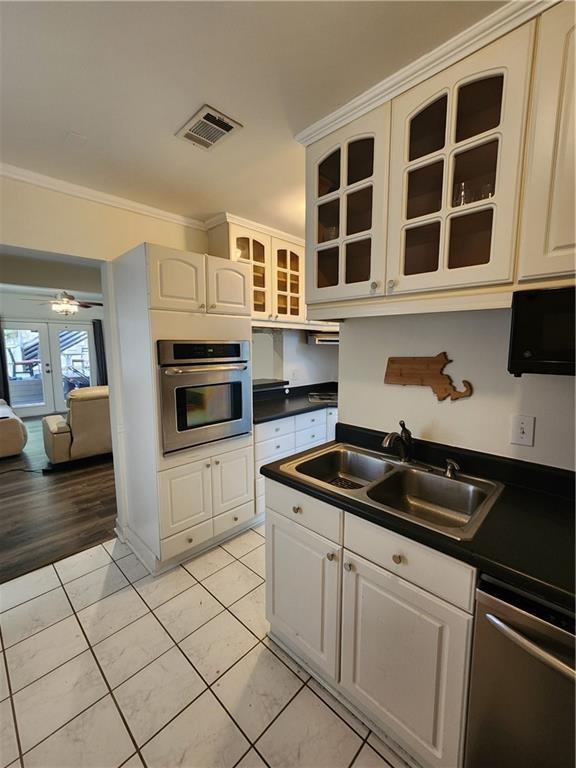 a kitchen with stainless steel appliances granite countertop a sink and a stove