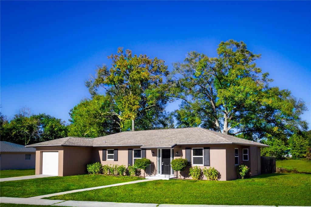 a front view of a house with a garden