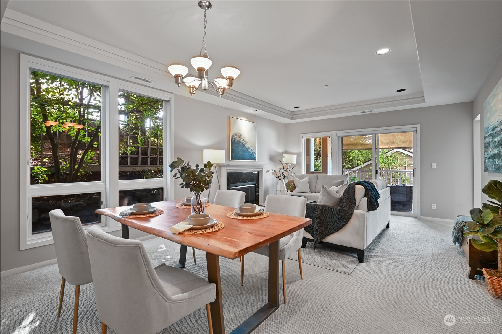 a view of a dining room with furniture a livingroom and chandelier