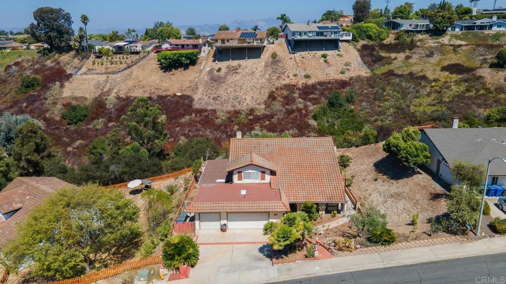 an aerial view of a house with a garden and yard