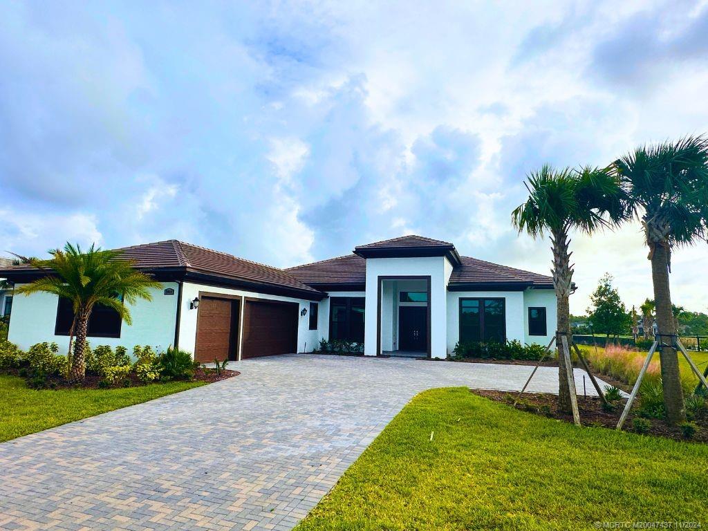 a front view of a house with a yard