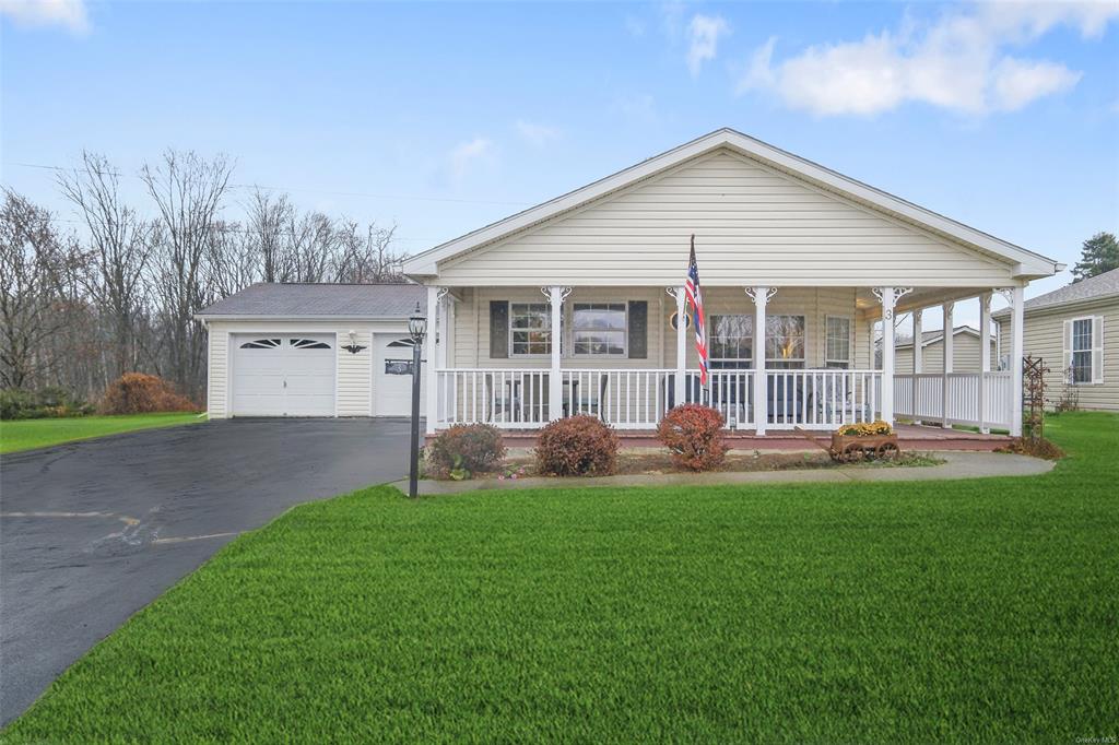 Single story home featuring a front lawn and a porch