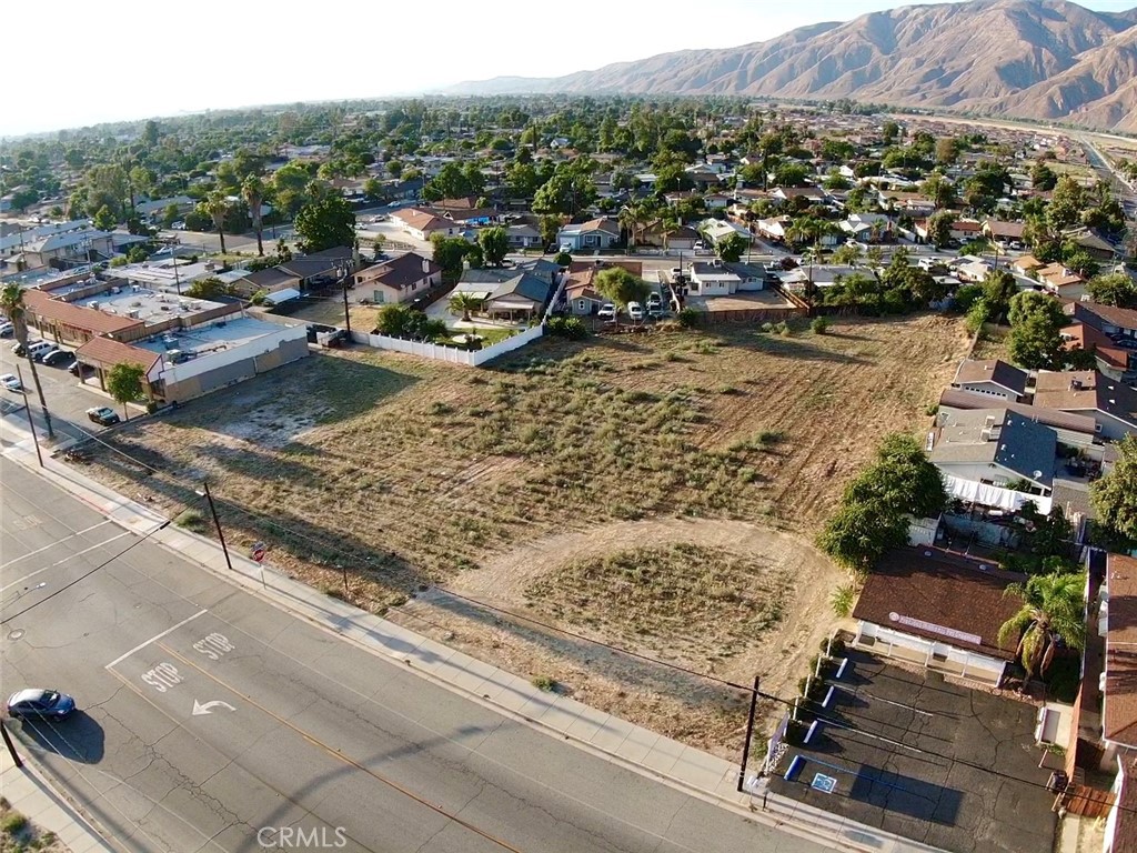 an aerial view of a residential houses with city view