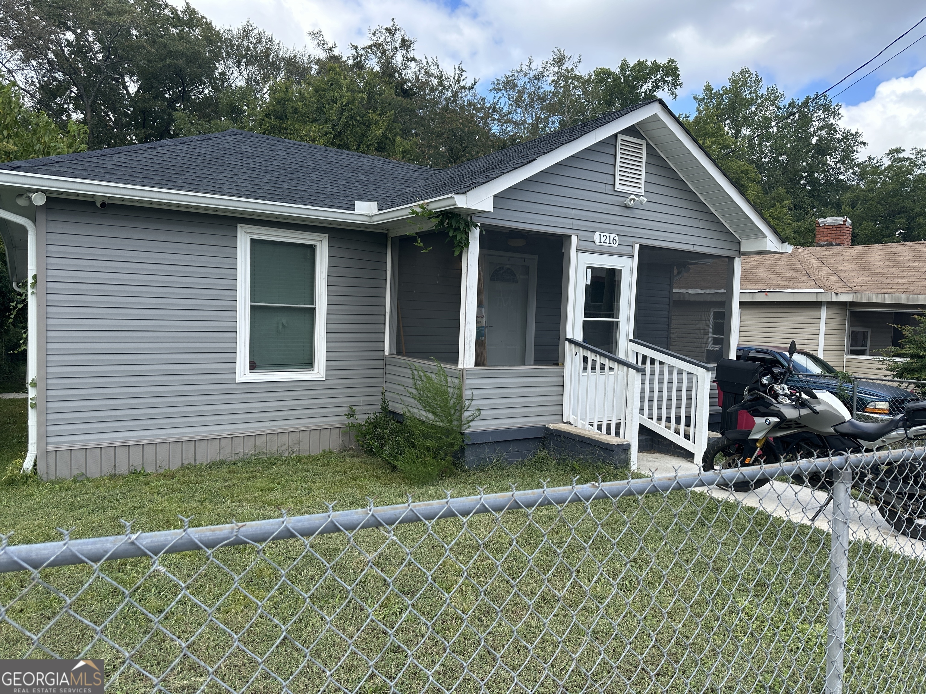 a view of a house with a small yard and a large window