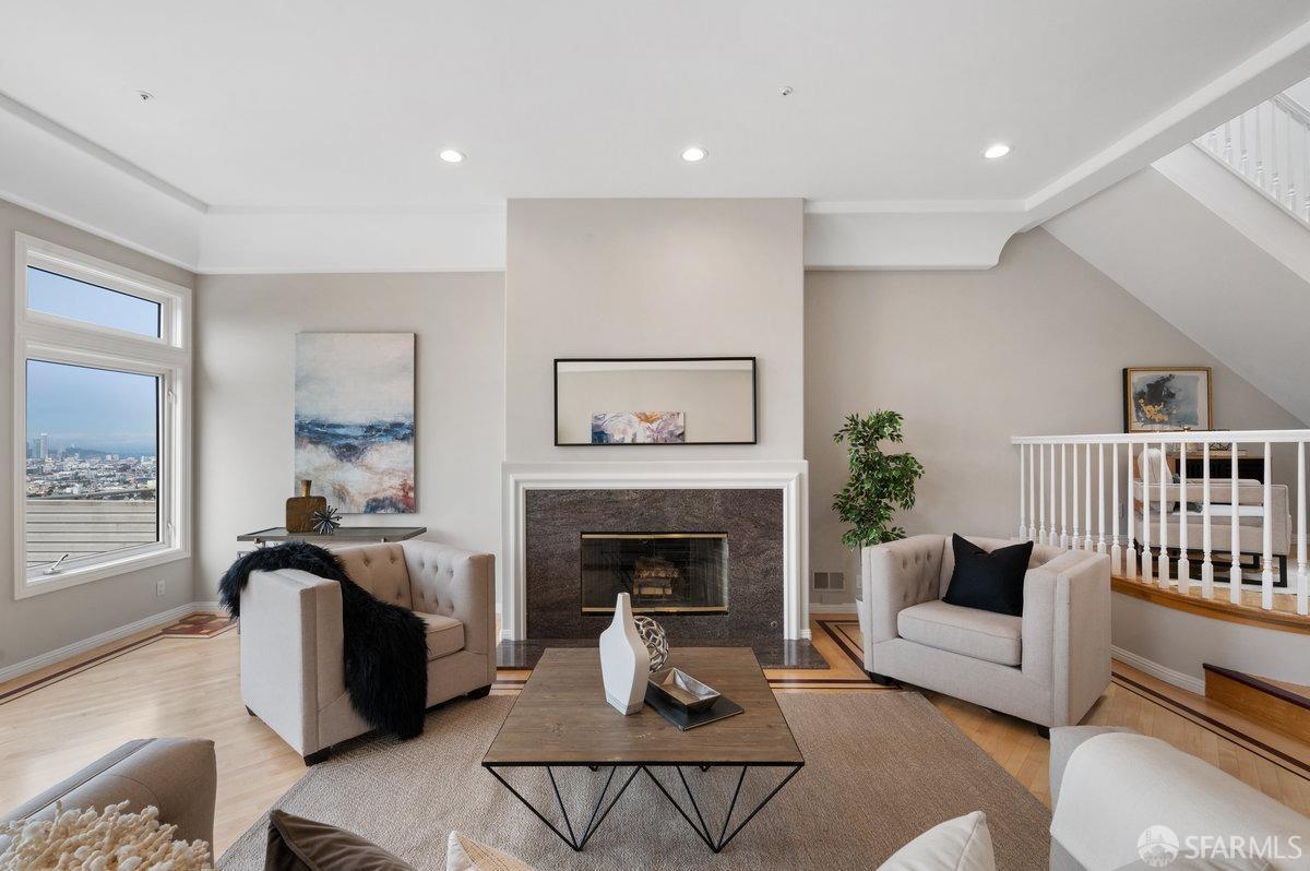 a living room with furniture and a fireplace